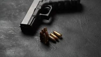 Possession-Of-Firearm-Paez-Defense Handgun with ammunition on surface | Possession-of-Firearm-Paez-Defense